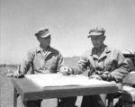 Brigadier General Franklin Hart and Major General Clifton Cates studying a map, Iwo Jima, Japan, Feb-Mar 1945