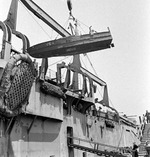 A captured Japanese Shinyo-class suicide boat being hoisted off of USS Pinkney after being brought to the United States for analysis, Alameda, California, United States, Jun 1945.