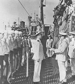 Rear Admiral Ralph Christie, Commander of Submarine Operations in the Southwest Pacific Area, reading the Presidential Citation to the captain and crew of USS Bowfin, Fremantle, Australia, Dec 1943.