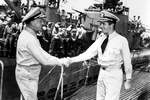 Vice Admiral Charles Lockwood, submarine commander in the Pacific, greeting Commander Alexander Tyree and USS Bowfin upon their return to Pearl Harbor, Hawaii from Bowfin’s ninth war patrol, 4 July 1945.