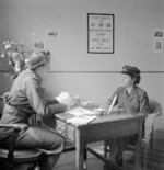 Leading Aircraftwoman Vera Blackbee speaking with a welfare officer, WAAF Demobilisation Centre, RAF Wythall, Worcestershire, England, United Kingdom, 1945