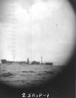 Photograph through the periscope of USS Skipjack of the torpedoed and sinking 7,000-ton freighter Shunko Maru 350 miles southwest of Truk, 14 Oct 1942.