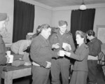 Sergeant Bert Turkentine (left; bomb aimer) and Sergeant Music (right; navigator; Canadian), crewmembers of a Lancaster bomber of No. 57 Squadron RAF, being offered tea by a WAAF member, 1940s