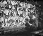 A WAAF storewoman checking parts in the spares section at No. 16 Maintenance Unit, RAF Stafford, Staffordshire, England, United Kingdom, date unknown