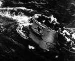 German submarine U-664 lying dead in the water and sinking by the stern as her crew abandoned ship following an air attack from USS Card aircraft in the mid-Atlantic, 9 Aug 1943. Photo 2 of 2.