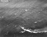 German submarine U-172 under attack by Lt(jg) James Ogle from Composite Squadron VC-19 flying from USS Bogue, 13 Dec 1943. Note approaching destroyer, probably USS Osmond Ingram.