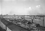View of Huangpu River and smoke rising on the horizon, Shanghai, China, mid-1937; note USS Augusta at anchor