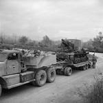 Diamond T tank transporter of 610 Heavy Recovery Section of British Royal Electrical and Mechanical Engineers carrying a Bishop 25-pdr self-propelled gun of 142nd Field Regiment of British Royal Artillery, Italy, 23 Dec 1943