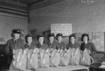 WAAF parachute packers ACW1 Sheina Brown, ACW1 Edith Tindle, ACW1 Olive Snow, Corporal Doris Mothersole, Sergeant Betty Jones, LACW Phyllis Baduchowska, and ACW1 Anne Douglas at the Parachute Training School, RAF Ringway, Cheshire, England, United Kingdom, 1944