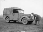 A WAAF driver turning the starting handle of a Standard 5-cwt van, Cardington, Bedfordshire, 1940s