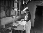 WAAF member peeling potatoes in the kitchens of RAF Debden, Essex, England, United Kingdom, 1940s