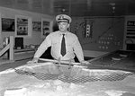 United States Navy Lieutenant L.A. Wilson in front of a model of the submarine net across San Francisco’s Golden Gate, Tiburon Naval Net Depot, 1951.