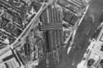 Aerial view of Friedrich Krupp Germaniawerft, Kiel, Germany, 1941; note heavy cruiser Prinz Eugen moored near the slips and a Königsberg-class cruiser to the aft