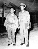 New York Times reporter William Laurence and Army information officer Major George Monyhan in front of a B-29 bomber on Tinian, Mariana Islands, 9 Aug 1945.