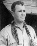 Lieutenant Commander Albert O. Vorse with his lucky green scarf aboard USS Ticonderoga at Pearl Harbor, Hawaii on the day he assumed command of Air Group 80, 16 Oct 1944.