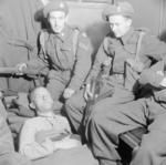 William Joyce in an ambulance under armed guard with a thigh gunshot wound, Flensburg, Germany, 29 May 1945, photo 1 of 3