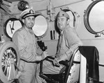 Commanding officer of USS Nicholas LtCdr Andrew Hill (left) and Commanding officer of Destroyer Squadron 21 Cdr Francis McInerney (right) in the pilothouse of the Nicholas, Mar-Aug 1943.