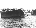 Following a torpedo hit to USS Honolulu’s bow on 13 Jul 1943 in the Battle of Kolombangara, the leading 36-feet of the bow structure collapsed to hang straight down. Photo taken at Tulagi. Photo 1 of 2.