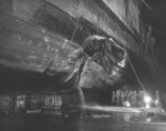 Torpedo damage to the hull of cruiser USS Honolulu after being torpedoed in Leyte Gulf on 20 Oct 1944. This photo was taken in floating drydock ABSD-2 at Seeadler Harbor, Manus, Admiralty Islands on 30 Oct 1944.