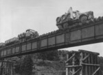 Sumida M.2593 (Army Type 91) armored car leading another vehicle across a railway bridge, circa 1930s