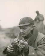 Ernie Pyle eating C-ration, Anzio, Italy, 18 Mar 1944