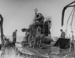 Wrecked Mikazuki being inspected by USMC personnel, off Cape Gloucester, New Britain, 8 Feb 1944; note searchlight, radio direction finder, and torpedo reloading tracks