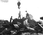 Scrap pieces of all types being loaded onto an Army barge at Berth 23, Pearl Harbor Navy Yard, Pearl Harbor, Hawai