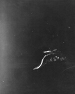 View from a USAAF B-17 bomber of Japanese destroyers Amatsukaze (bottom, sailing at speed) and Tokitsukaze (right, slowly backing away from the carrier) evacuating crew of the disabled carrier Ryujo (center, immobile), Battle of the Eastern Solomons, 24 Aug 1942, photo 2 of 3