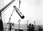 A Mark 10 torpedo afterbody being hoisted aboard the USS S-31 from the submarine tender USS Beaver, circa 1927.