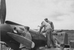 Crews servicing a North American A-36A Mustang aircraft of US 86th BFG, late 1943; note the chin-mounted guns and the bombing mission markings on the cowl