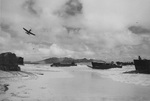 US Army assault landing training at Bellows Field (Waimanalo Beach), Oahu, US Territory of Hawaii, 1945; note P-39 Airacobra aircraft, CCKW trucks, and Wailea Point in background