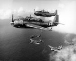 TBM-1C Avenger aircraft flying from the USS Intrepid, 1944; note five low flying aircraft below lower element