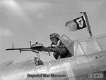 A British sergeant air-gunner manned his Vickers K gun from the rear cockpit of a Fairey Battle, May 1940; note the unofficial squadron pennant flying from the radio mast