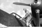 German pilot Oberleutnant Theodor Rossiwall preparing to enter his Bf 110 fighter, western France, summer 1940