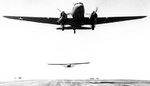 C-47 Skytrain aircraft towing CG-4A glider off an Algerian airstrip, Feb-Jun 1943