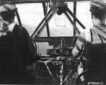 Glider pilots of the US 52nd Troop Carrier Wing flying a Waco CG-4A glider above Comiso Airfield in Sicily, Italy, 1943; tow rope attached above the glider cockpit seen through the wind screen