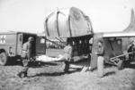 USAAF Troop Carrier Command demonstrating loading a wounded man onto a CG-4A glider, Roosevelt Field, Long Island, New York, United States, 24 Mar 1945; note Dodge WC54 ambulance