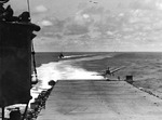 SBD Dauntless aircraft landing aboard USS Hornet during the Battle of Midway, 4 Jun 1942; note Landing Signal Officer undernearth the landing aircraft