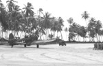 A-24B-5-DT Banshee aircraft (serial number 42-54459) of US 531st Fighter Squadron following a Jeep down the runway on Makin Island, Gilbert Islands, 13 Dec 1943; this was the first A-24B to arrive on Makin