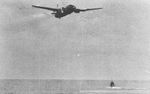 G4M1 bomber of Japanese Navy 4th Air Group, piloted by Lieutenant Commander Takuzo Ito, moments before crashing into sea during attack on USS Lexington off Bougainville, Solomon Islands, 20 Feb 1942