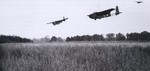 Hamilcar gliders of 6th Airlanding Brigade carrying light armored vehicles coming into landing near Ranville, France, afternoon of 6 Jun 1944; note gliders
