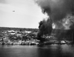 Peleliu, Palau Islands under attack by US Navy carrier aircraft, 30 Mar 1944; note F6F Hellcat fighter in flight