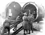 British troops loading field gun aboard Horsa Mk II glider with glider nose section swung away, date unknown