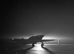 British Hurricane fighter of No. 85 Squadron RAF taxiing at Debden, Essex, England, United Kingdom at night, 14 Mar 1941; note navigation lights on wingtips