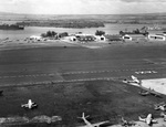 View of Naval Air Station Ford Island, Oahu, US Territory of Hawaii, Jan or Feb 1942; note J2F Duck, JRS, OS2U, and R3D (tail only) aircraft, USS Curtiss, and Northampton-class cruisers