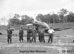 Japanese Navy pilots at Seletar Airfield, Singapore with a captured J2M Raiden fighter in RAF markings, Dec 1945