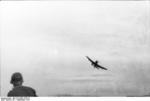 German Ju 87 Stuka aircraft flying low to the ground, Italy, Sep 1943; this particular aircraft was modified for glider towing