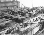 P-38 Lightning aircraft loaded aboard an escort carrier for ferrying to Europe, New York, United States, date unknown