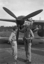 USAAF pilots Thomas McGuire and Charles Lindbergh after returning from a combat mission, at Biak Island off New Guinea, circa Jul 1944; note P-38 Lightning aircraft, possibly McGuire