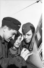 German airmen painting markings on the rudder of a Bf 109 fighter, Russia, 1942, photo 2 of 2